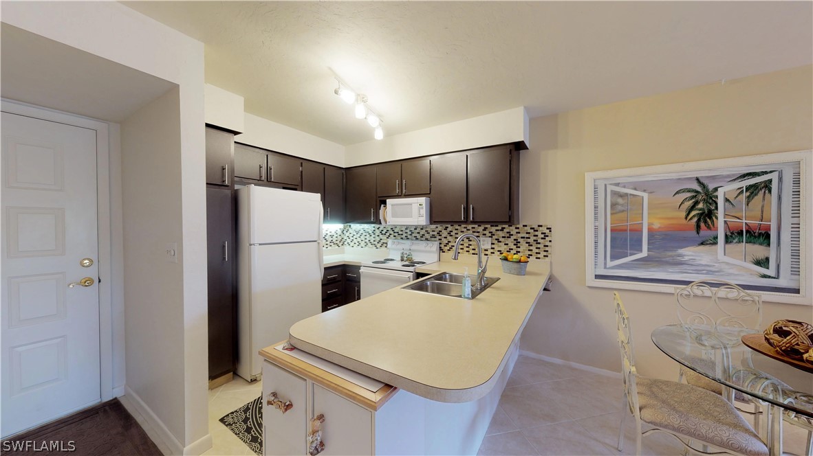 1100 Pondella Road, Unit 811 Cape Coral, FL 33909 - Photo 3 of 35 a kitchen with refrigerator and cabinets