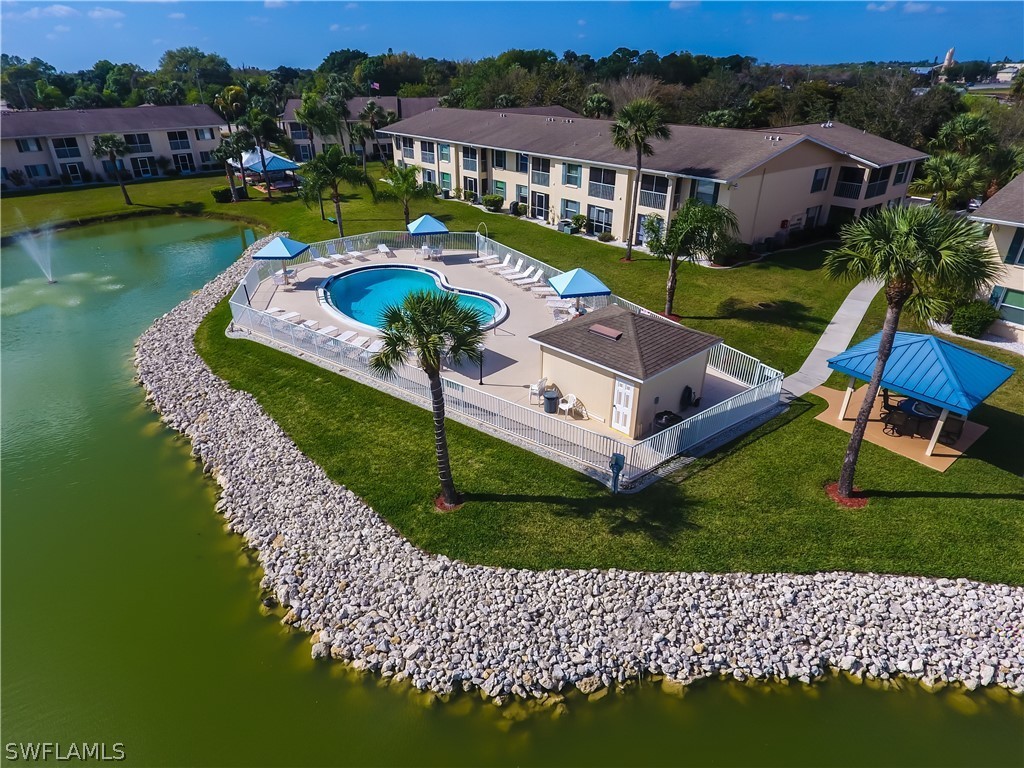 1100 Pondella Road, Unit 811 Cape Coral, FL 33909 - Photo 32 of 35 an aerial view of a house with a garden and lake view