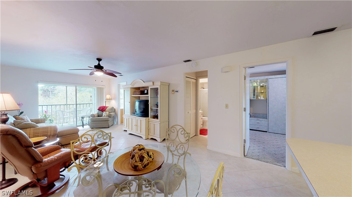 1100 Pondella Road, Unit 811 Cape Coral, FL 33909 - Photo 7 of 35 a living room with furniture a large window and wooden floor