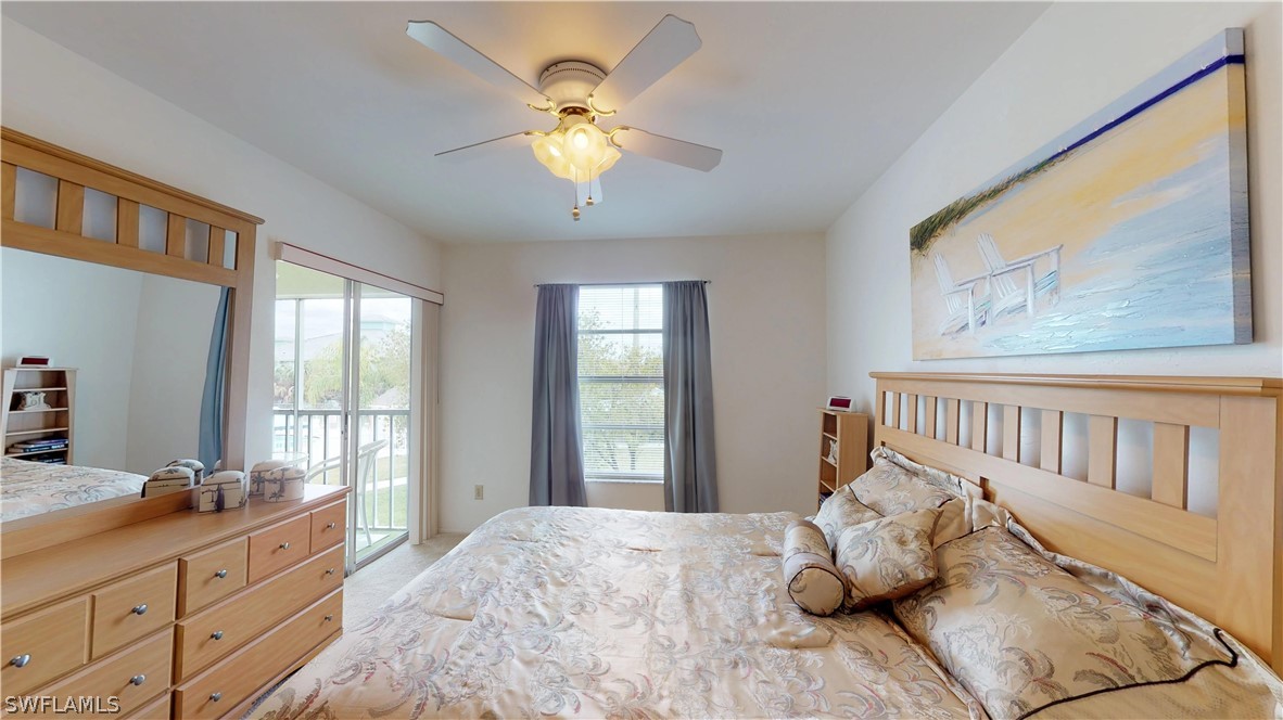 1100 Pondella Road, Unit 811 Cape Coral, FL 33909 - Photo 10 of 35 a bedroom with a bed and wooden floor
