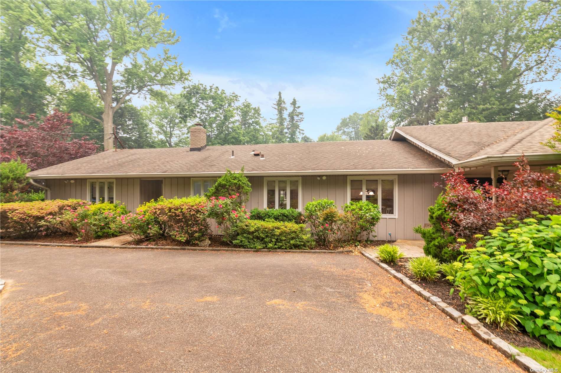 a front view of a house with a yard and outdoor seating
