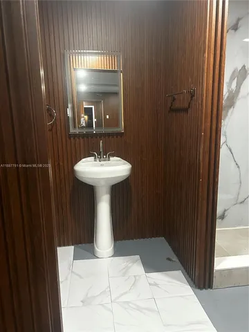 a bathroom with a sink a mirror and window
