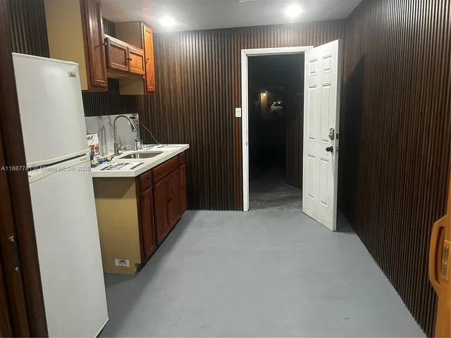 a kitchen with stainless steel appliances a refrigerator and a stove