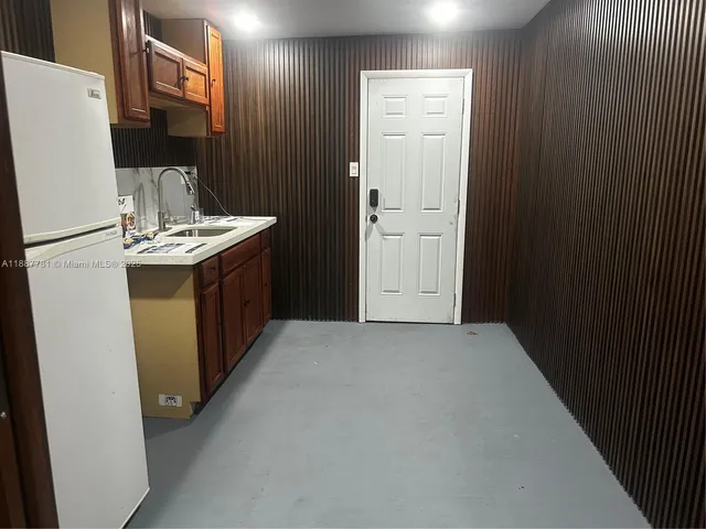 a kitchen with a sink and a refrigerator