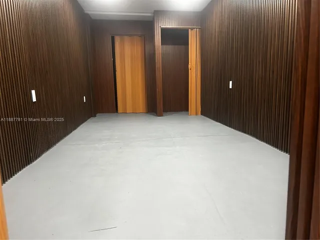 a view of an empty room with bathroom