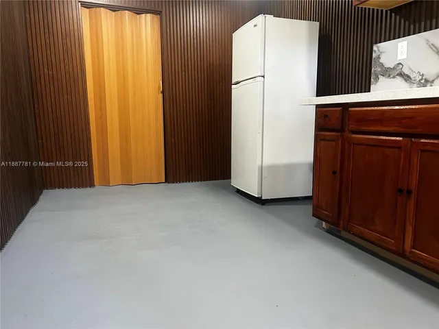 an empty room with closet and window