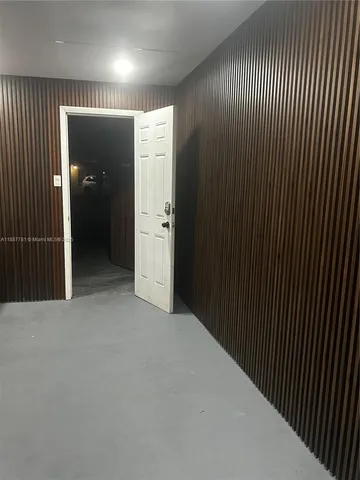 wooden floor in an empty room with a hallway