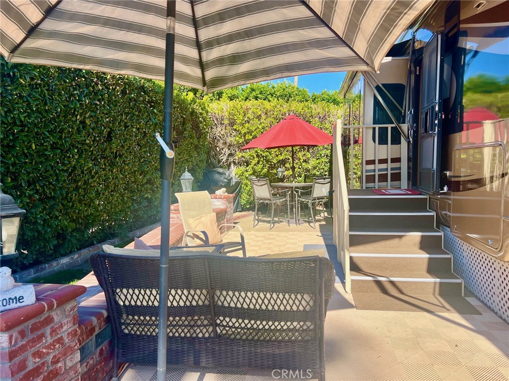 a view of a patio with a table and chairs