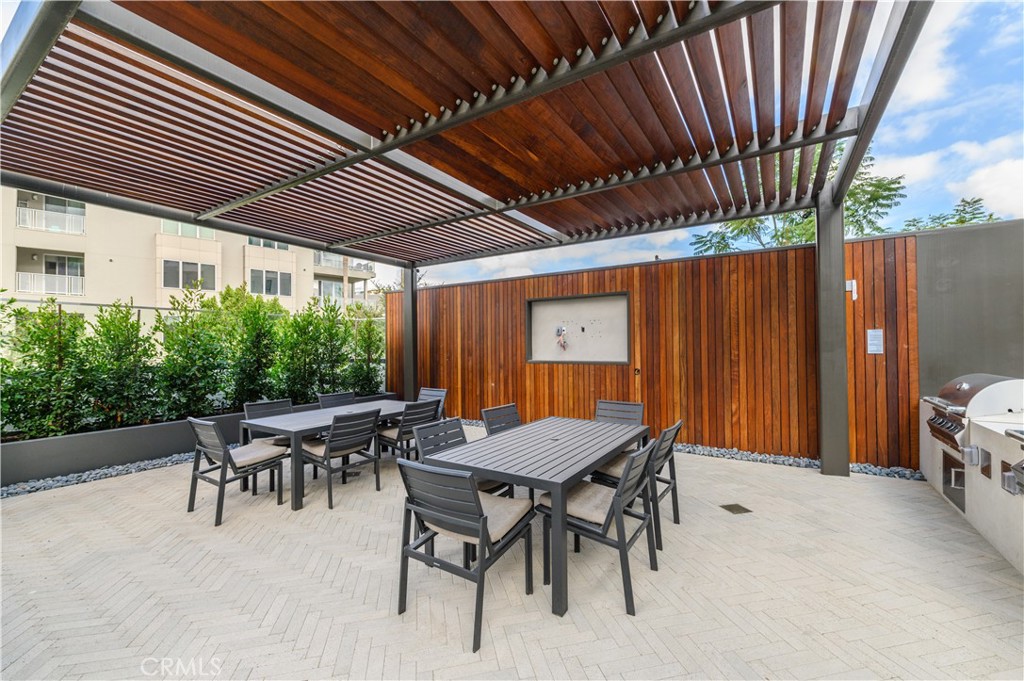 3608 Rivington Irvine, CA 92612 - Photo 61 of 74 a view of a patio with table and chairs with wooden floor and fence