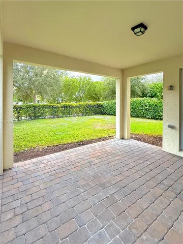 a view of a room with a large windows and a yard
