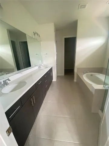 a bathroom with a double vanity sink and mirror