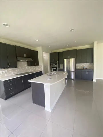 a large white kitchen with a large window