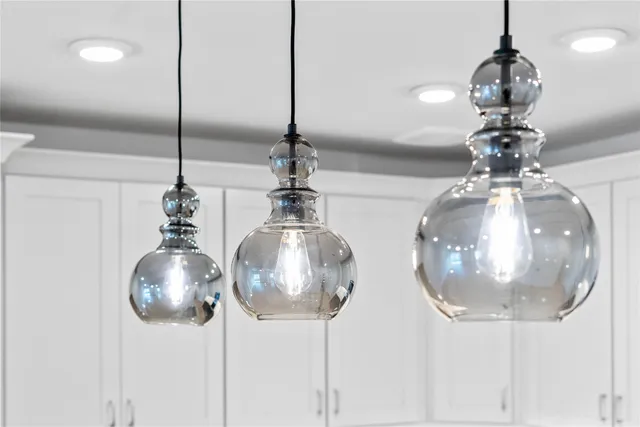 an empty room with wooden floor fireplace and windows