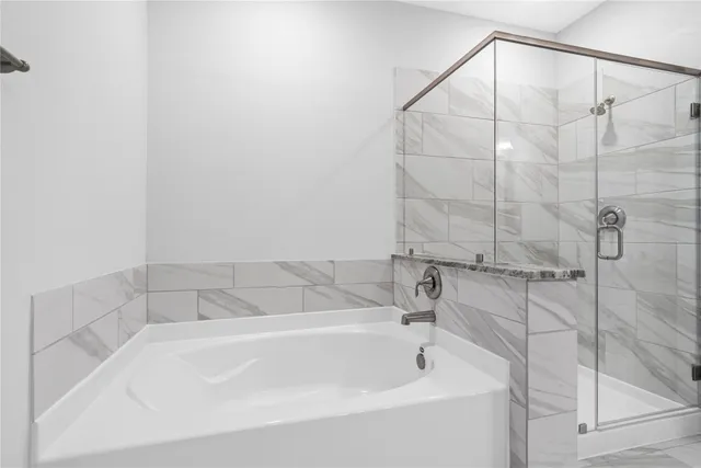 a bathroom with a granite countertop sink a toilet and a bathtub