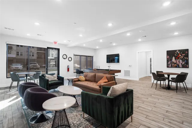 a dining area with furniture and a chandelier