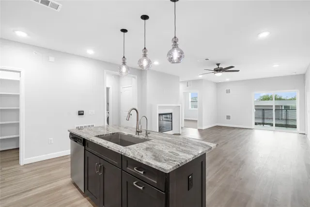 a kitchen with granite countertop a stove and a sink