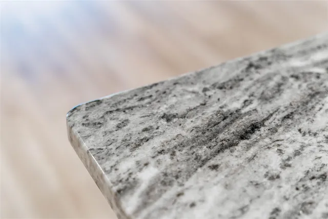 an empty room with wooden floor fireplace and windows