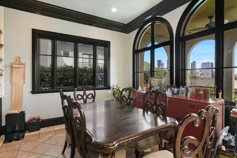 a view of a dining room with furniture large windows and wooden floor