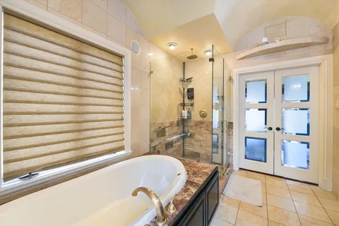 a bathroom with a bathtub and a shower