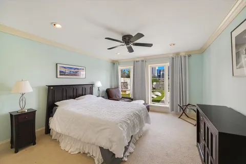 a spacious bedroom with a bed and a chandelier
