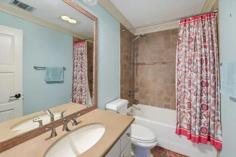 a bathroom with a sink toilet tub and shower