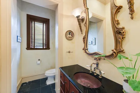 a bathroom with a sink a toilet and mirror
