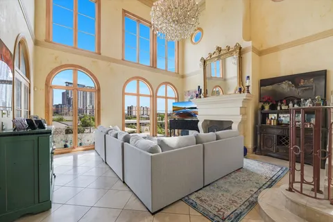 a living room with patio furniture and a fireplace