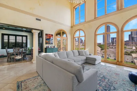 a living room with fireplace furniture and a large window