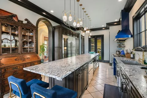 a dining hall with furniture and chandelier