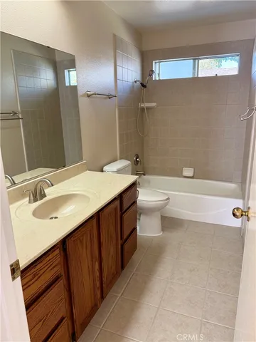 a bathroom with a double vanity sink toilet and shower