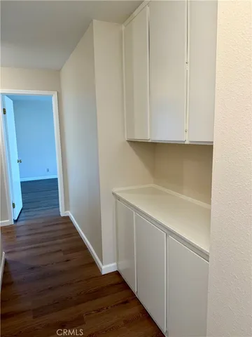 a view of storage and utility room with wooden floor