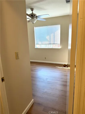 a view of a room with wooden floor and windows