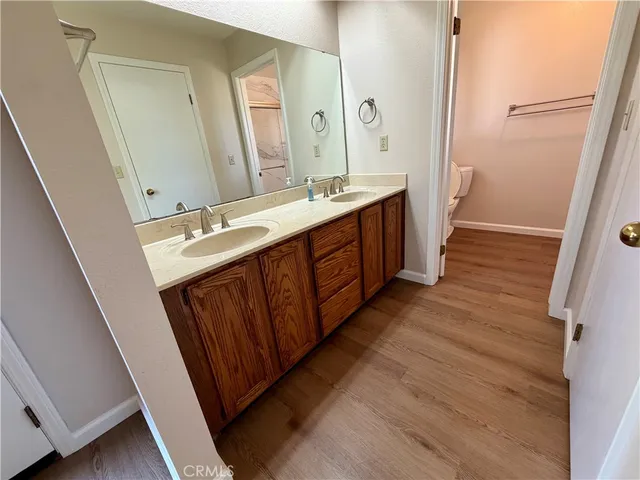a spacious bathroom with a double vanity sink and a mirror