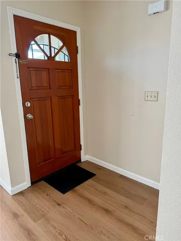 a view of front door with wooden floor