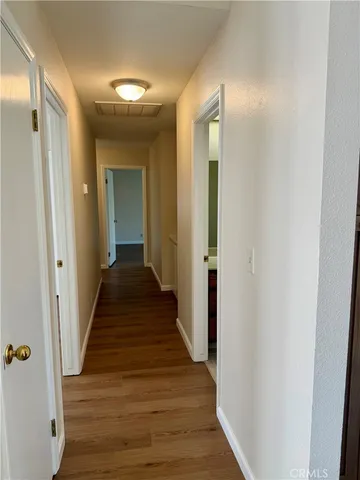 a view of a hallway with wooden floor