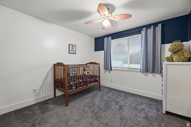 822 Pinewood Circle Price, UT 84501 - Photo 15 of 49 Room featuring gray carpeting, window with blinds, and a ceiling fan