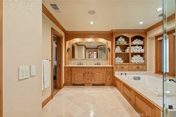 a bed room with a bed mirror and a ceiling fan