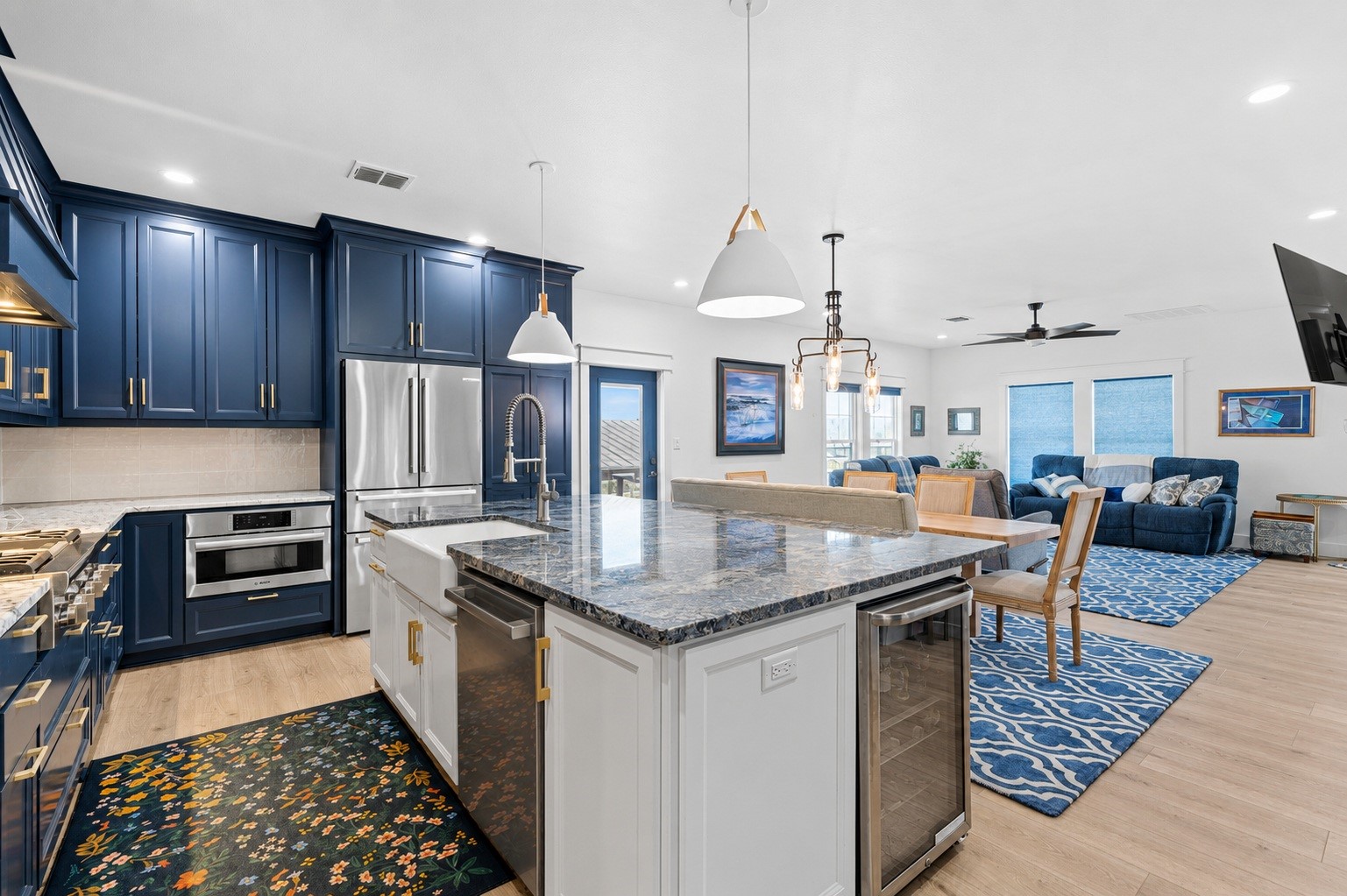 29 Rabbit Drive Port O'Connor, TX 77982 - Photo 5 of 21 Virtually Cleaned: This open kitchen showcases high-end finishes. The spacious island offers an apron-front sink and wine/beverage cooling, anchoring the transition into the dining and living spaces.