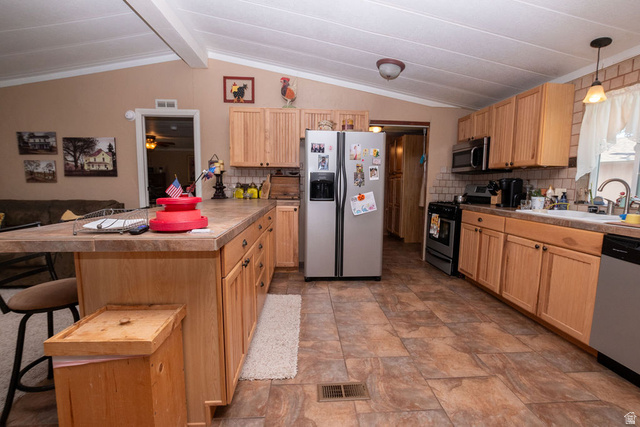 855 East 300 N Street Beaver, UT 84713 - Photo 28 of 44 Spacious kitchen featuring light wood-finish cabinetry, a central island with an extended countertop, and a tiled backsplash