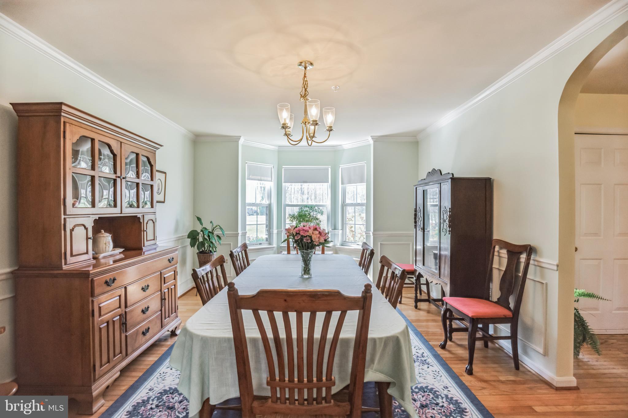 540 Small Reward Road Huntingtown, MD 20639 - Photo 8 of 26 a view of a dining room with furniture a rug and wooden floor