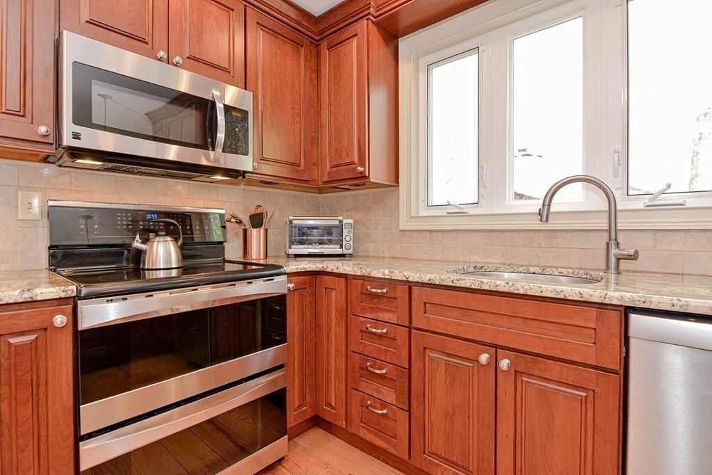 40 Southboro Road Upton, MA 01568 - Photo 14 of 42 a kitchen with granite countertop cabinets stainless steel appliances a sink and window