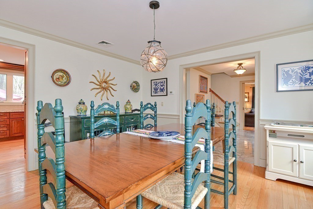 40 Southboro Road Upton, MA 01568 - Photo 4 of 42 a dining room with wooden floor a chandelier a wooden table and chairs