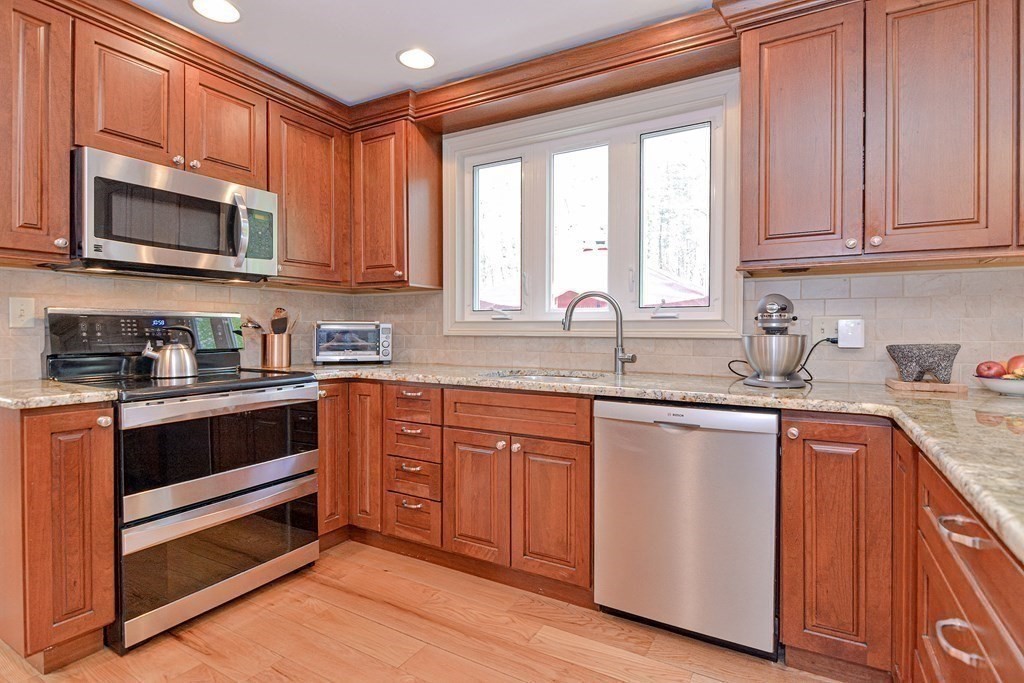 40 Southboro Road Upton, MA 01568 - Photo 10 of 42 a kitchen with stainless steel appliances granite countertop a stove a sink and a microwave