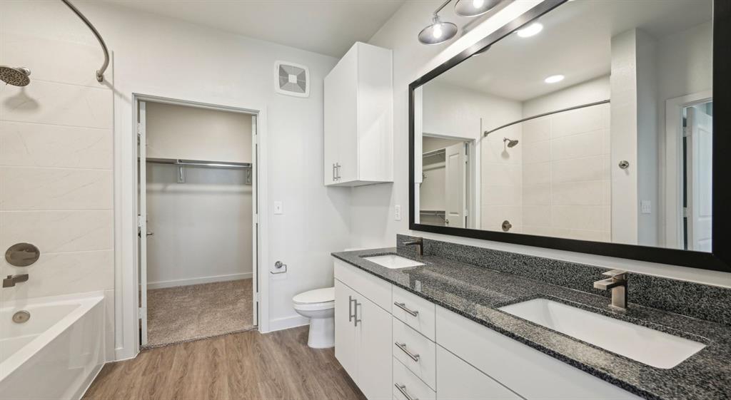 4600 East McKinney Street, Unit 5317 Denton, TX 76208 - Photo 23 of 40 a bathroom with a granite countertop sink toilet and shower