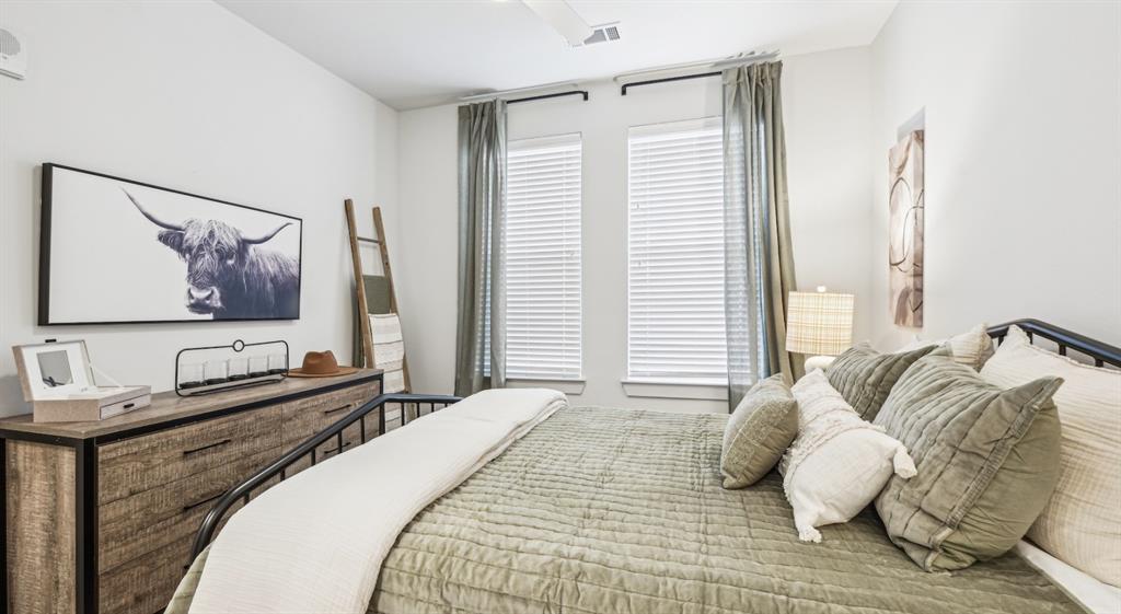 4600 East McKinney Street, Unit 5317 Denton, TX 76208 - Photo 34 of 40 a bedroom with a bed and a flat screen tv