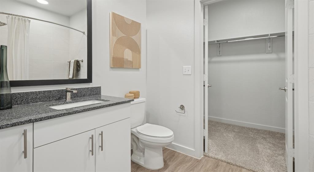 4600 East McKinney Street, Unit 5317 Denton, TX 76208 - Photo 39 of 40 a bathroom with a granite countertop sink toilet a mirror and shower