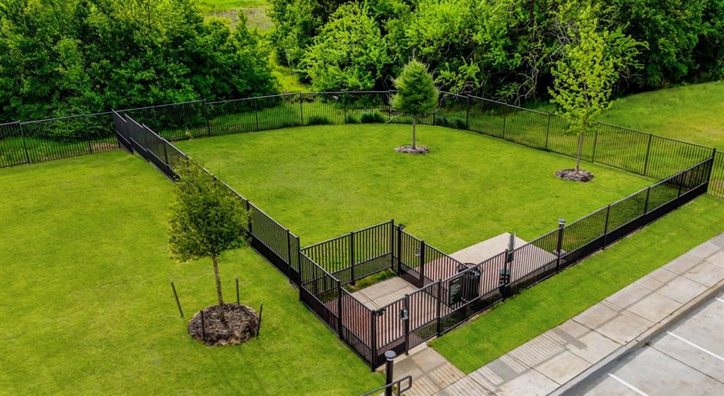 4600 East McKinney Street, Unit 5317 Denton, TX 76208 - Photo 9 of 40 a view of a tennis ground with large trees