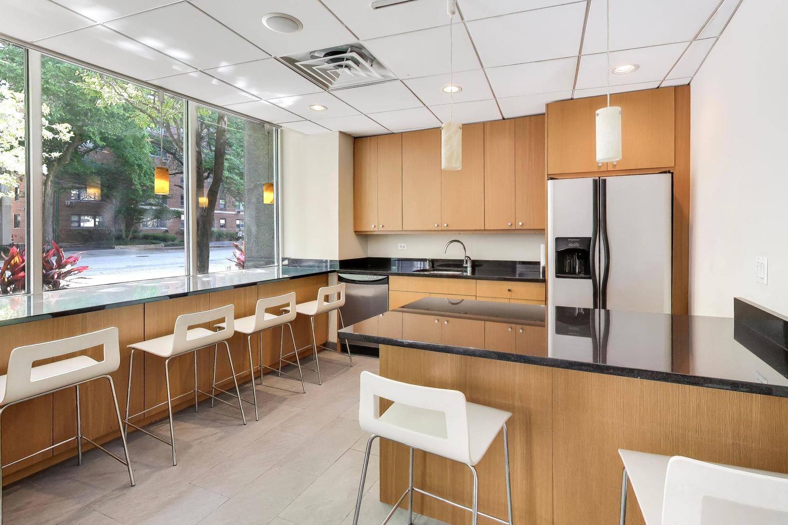 2930 North Sheridan Road, Unit 702 Chicago, IL 60657 - Photo 16 of 25 a kitchen with counter top space and stainless steel appliances
