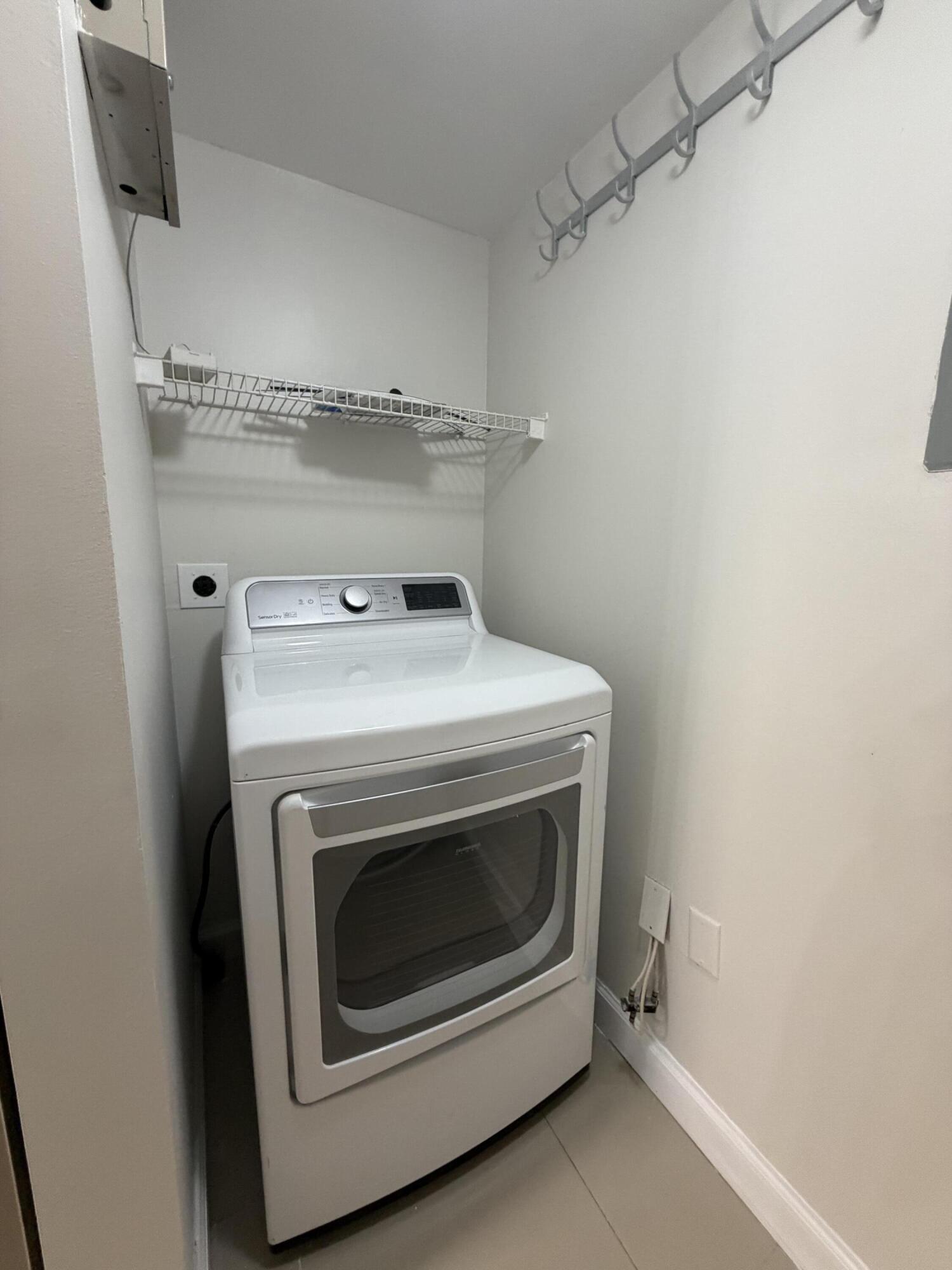5031 Wiles Road, Unit 203 Coconut Creek, FL 33073 - Photo 13 of 24 a utility room with dryer and washer