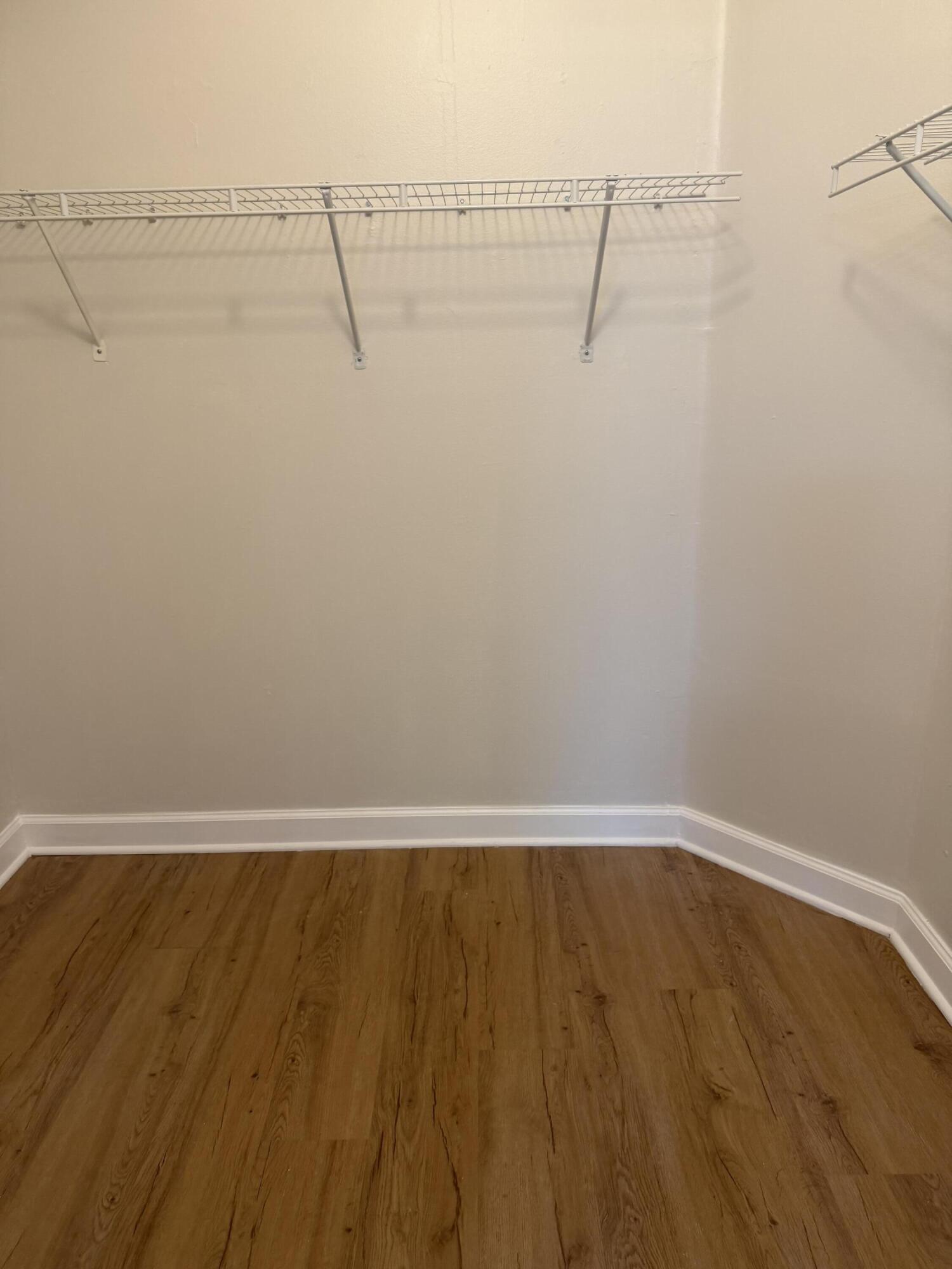 5031 Wiles Road, Unit 203 Coconut Creek, FL 33073 - Photo 16 of 24 a view of a room with racks on the wall